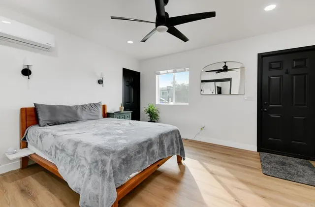 a spacious bedroom with a bed and a chandelier