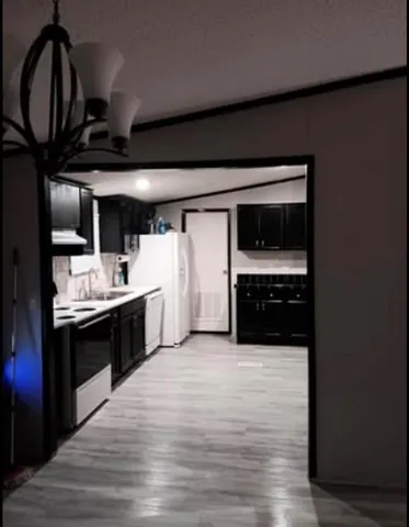 a kitchen with a stove and a refrigerator