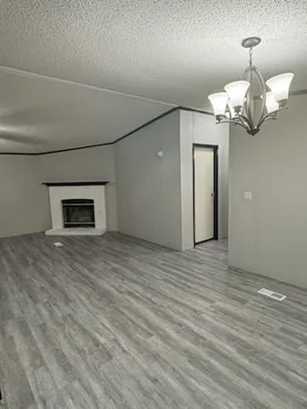 a view of a room with wooden floor