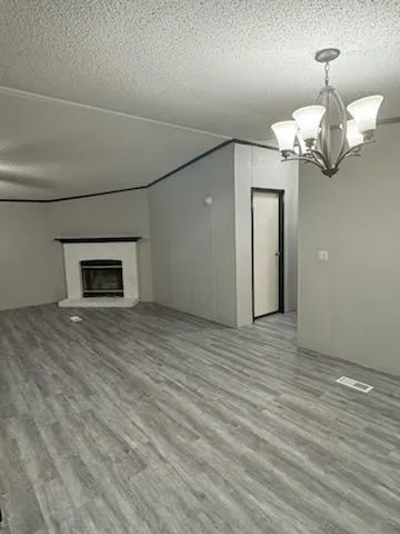 a view of a room with wooden floor