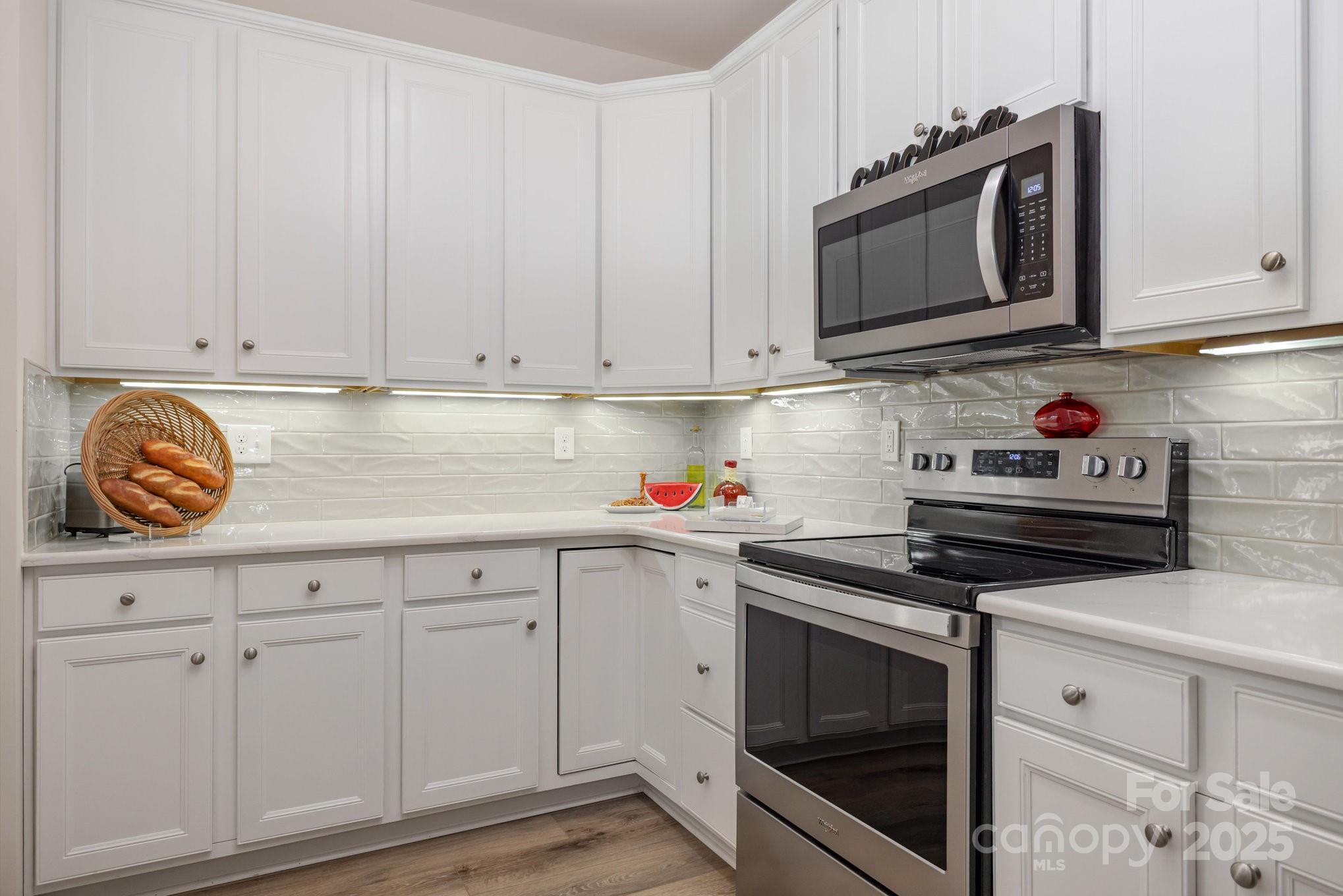 881 Platinum Drive Fort Mill, SC 29708 - Photo 15 of 35 a kitchen with granite countertop white cabinets and stainless steel appliances