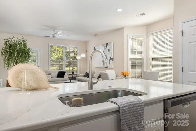 a kitchen with a sink and a large window
