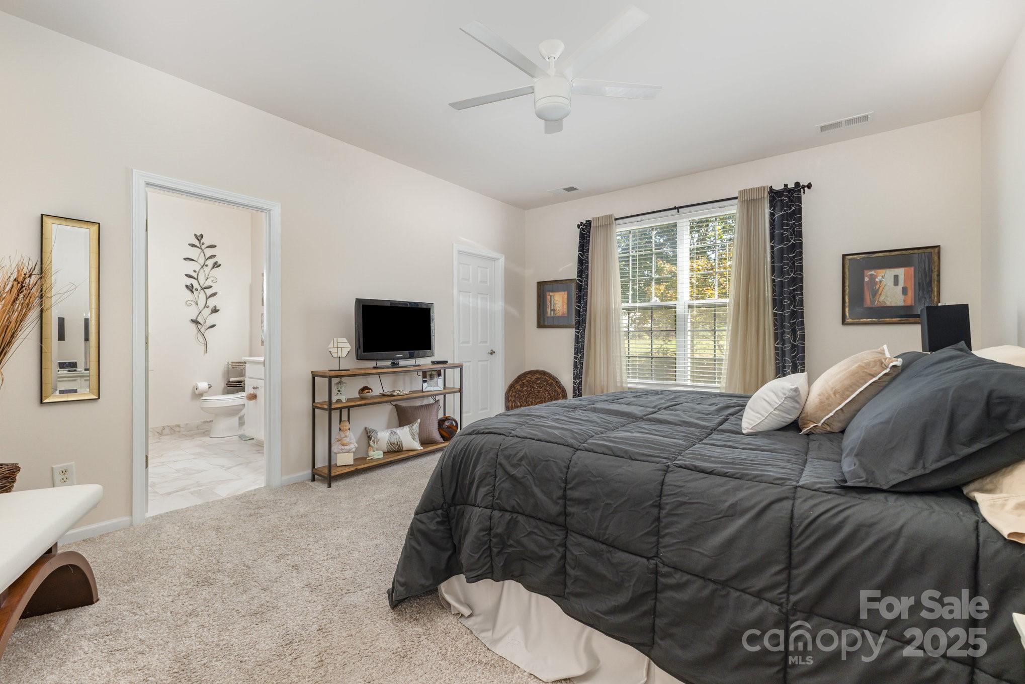 881 Platinum Drive Fort Mill, SC 29708 - Photo 28 of 35 a bedroom with a bed and a flat screen tv