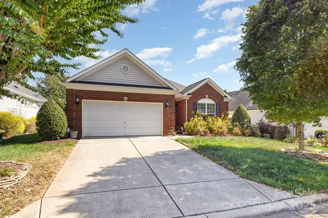 a front view of a house with yard and garage