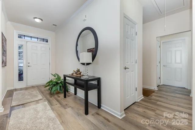 a view of a room that has a bench and a potted plant on table