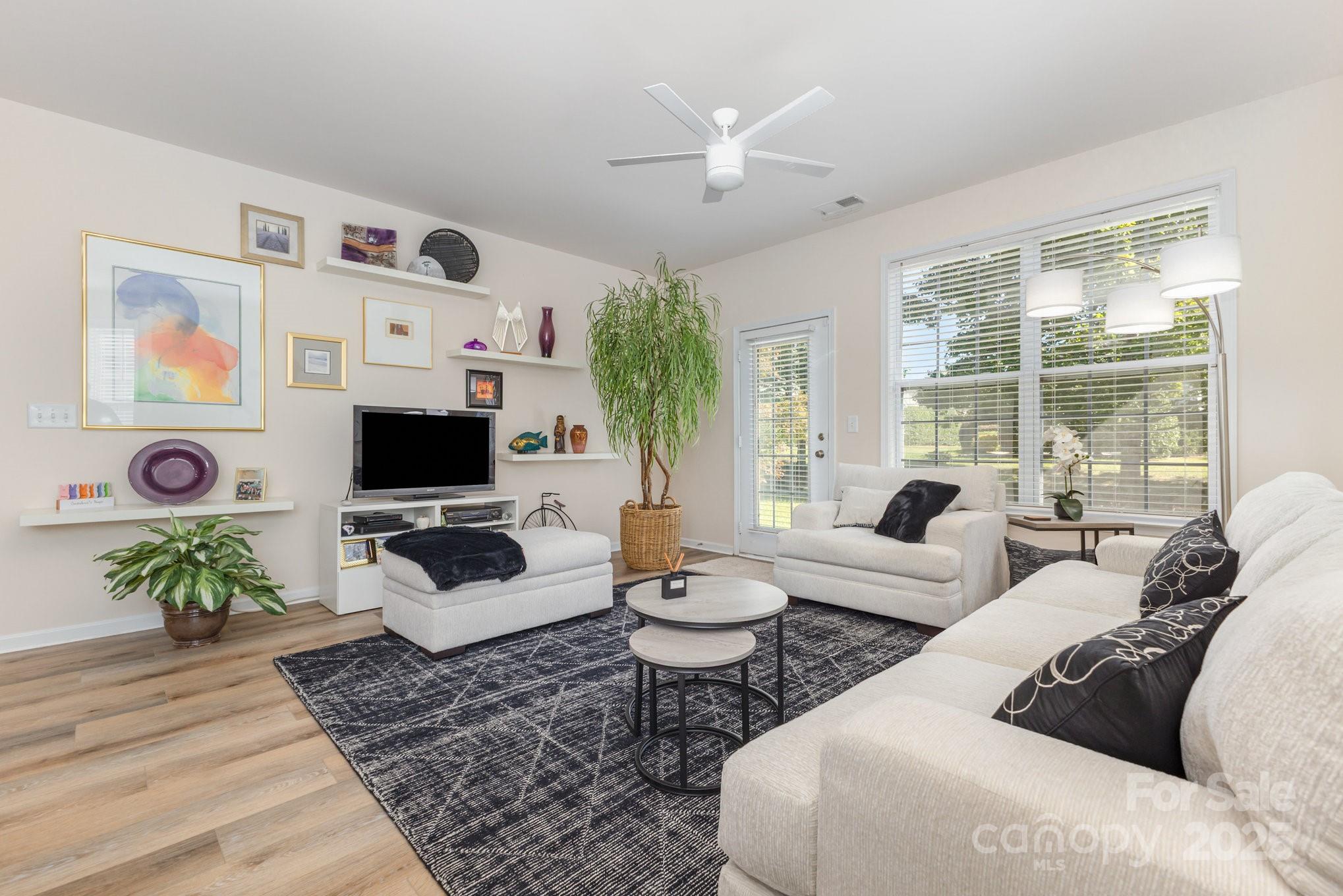 881 Platinum Drive Fort Mill, SC 29708 - Photo 8 of 35 a living room with furniture a flat screen tv and a large window