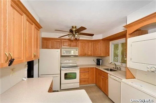 a kitchen with a sink a refrigerator and cabinets