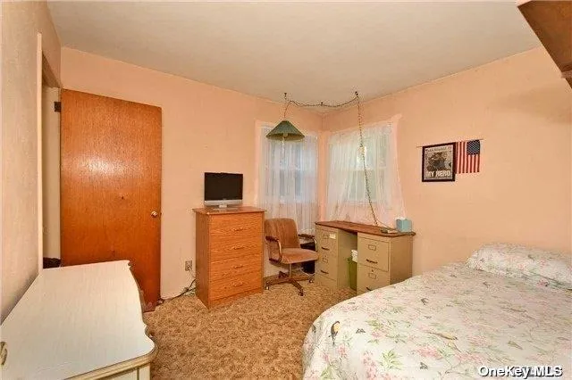 a bedroom with a bed and a desk