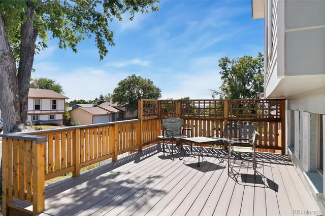 a view of balcony with wooden floor and seating space