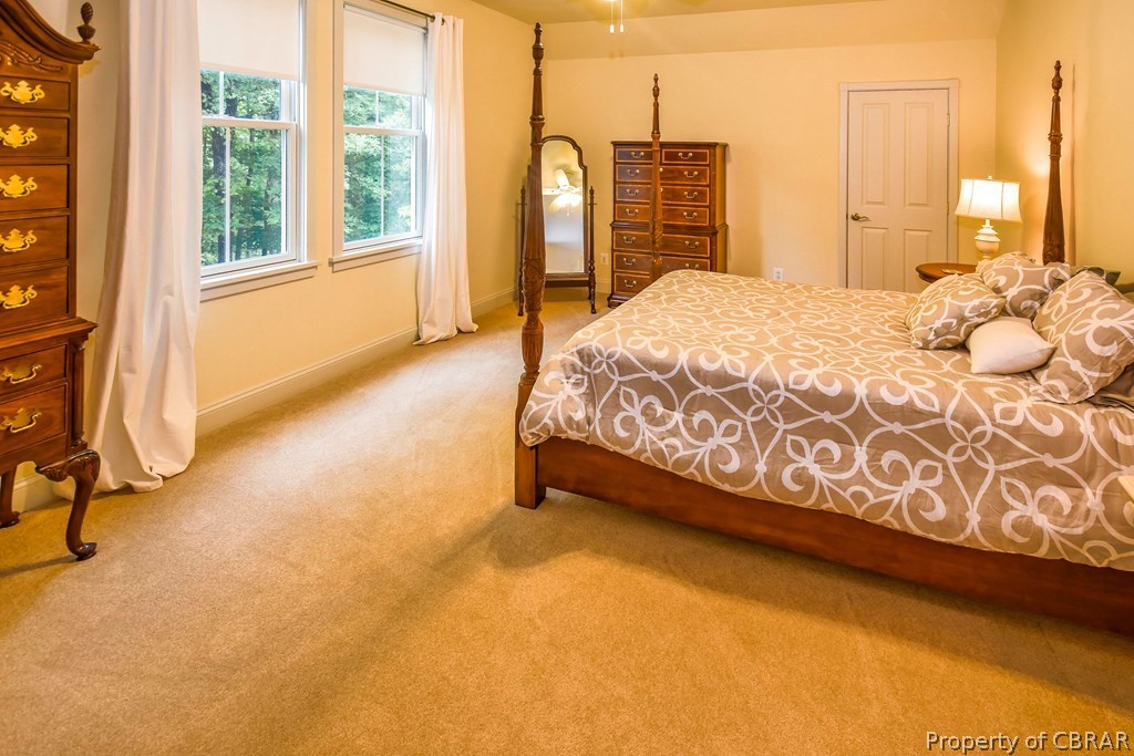 137 Mastons Wharf Road Lancaster, VA 22503 - Photo 23 of 39 a spacious bedroom with a bed and a window