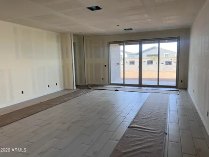 a living room with hard wood floors and white walls