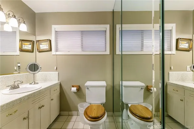 a bathroom with a toilet a sink and mirror