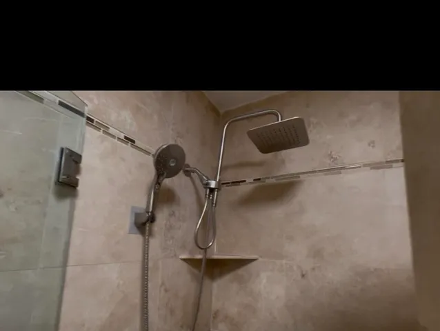 a bathroom with a shower and a sink