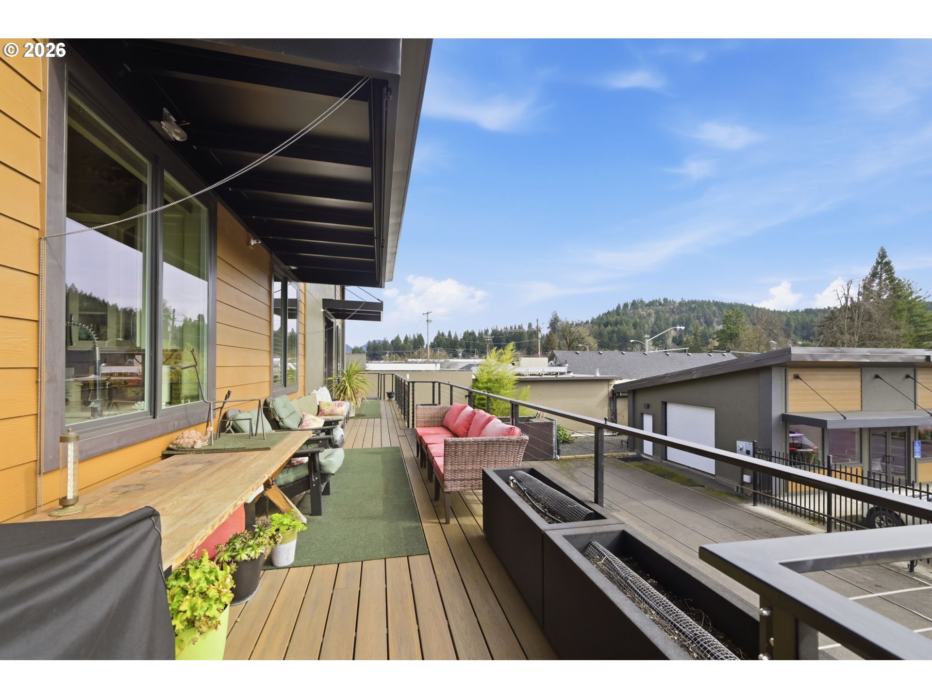 1308 East Main Street Cottage Grove, OR 97424 - Photo 22 of 48 a view of a balcony with couch and wooden floor