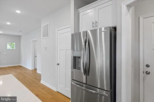 a large kitchen with kitchen island a sink stainless steel appliances and cabinets
