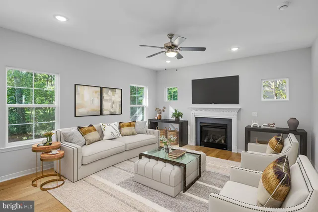 a living room with furniture a flat screen tv and a fireplace