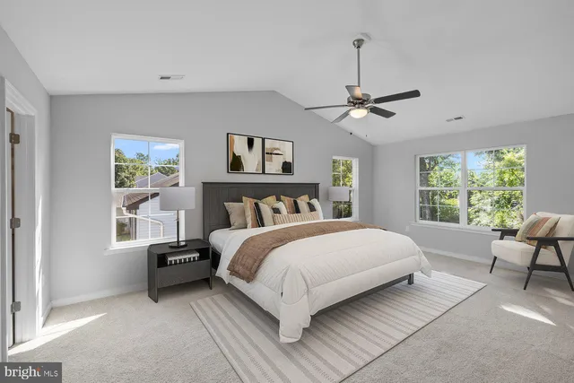 a bedroom with a large bed couch and a window