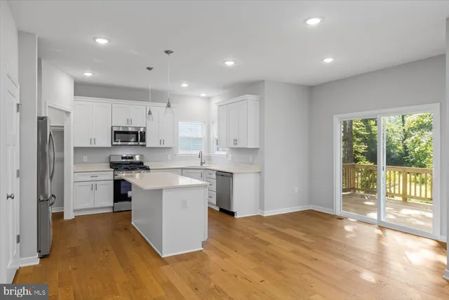 a kitchen with white cabinets and appliances