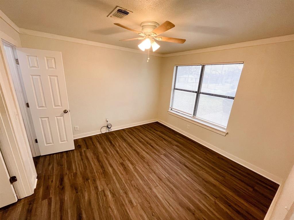206 East 3rd Street Tolar, TX 76476 - Photo 10 of 21 wooden floor in an empty room