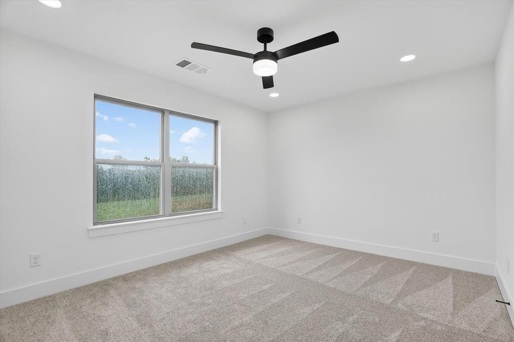 225 Kilkenny Road Poolville, TX 76487 - Photo 22 of 36 Contemporary room featuring a large window, plush carpet, recessed lighting, and a modern ceiling fan