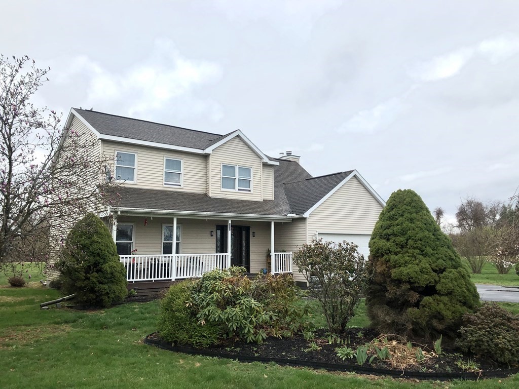 266 River Road Sunderland, MA 01375 - Photo 1 of 38 a view of a white house next to a yard with plants and trees