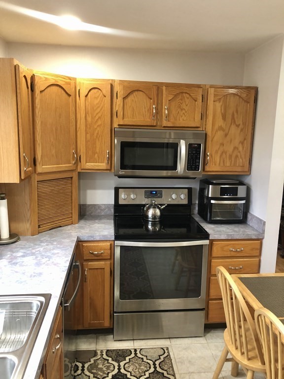 266 River Road Sunderland, MA 01375 - Photo 13 of 38 a kitchen with stainless steel appliances granite countertop a stove and a microwave