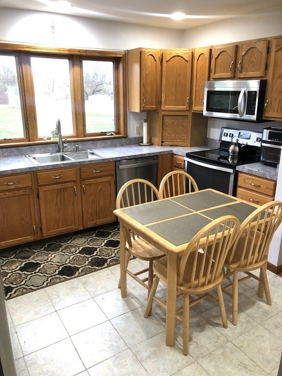 266 River Road Sunderland, MA 01375 - Photo 14 of 38 a view of a kitchen with kitchen island granite countertop a sink and a stove top oven