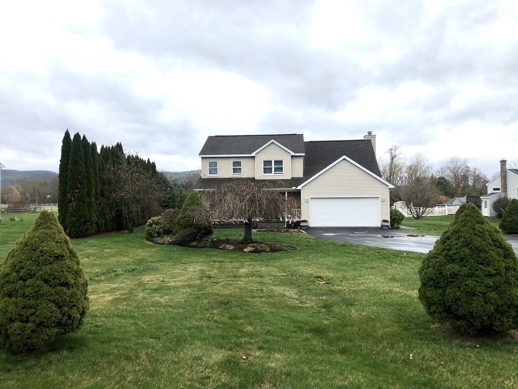 266 River Road Sunderland, MA 01375 - Photo 2 of 38 a aerial view of a house next to a big yard and large trees