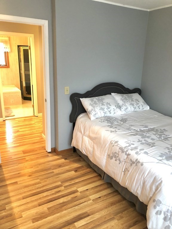 266 River Road Sunderland, MA 01375 - Photo 26 of 38 a bedroom with a bed and wooden floor
