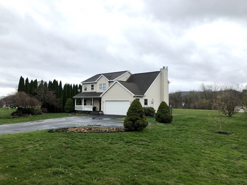 266 River Road Sunderland, MA 01375 - Photo 4 of 38 a view of a house with a big yard potted plants and large tree
