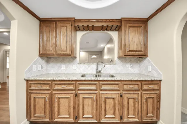 a bathroom with granite countertop a sink and a mirror