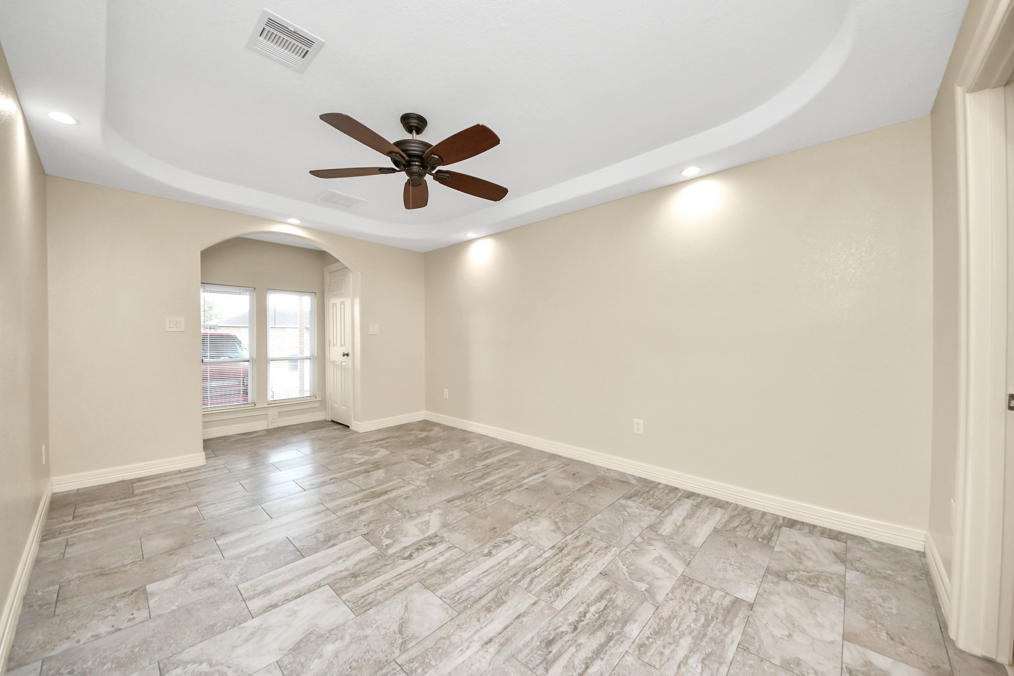 8925 Homewood Lane Houston, TX 77078 - Photo 14 of 28 a view of empty room with wooden floor and fan