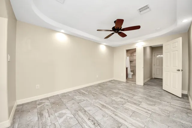 a view of empty room with ceiling fan