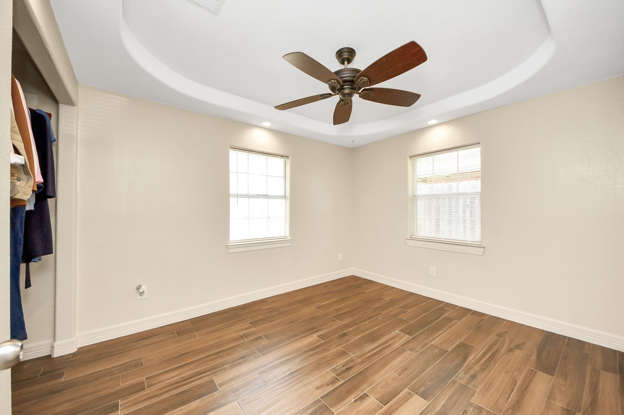 8925 Homewood Lane Houston, TX 77078 - Photo 22 of 28 a view of a big room with wooden floor closet and windows