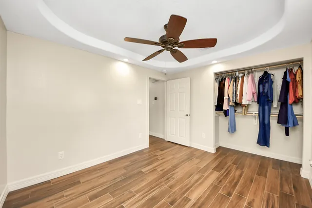 a view of a hallway with a wooden floor