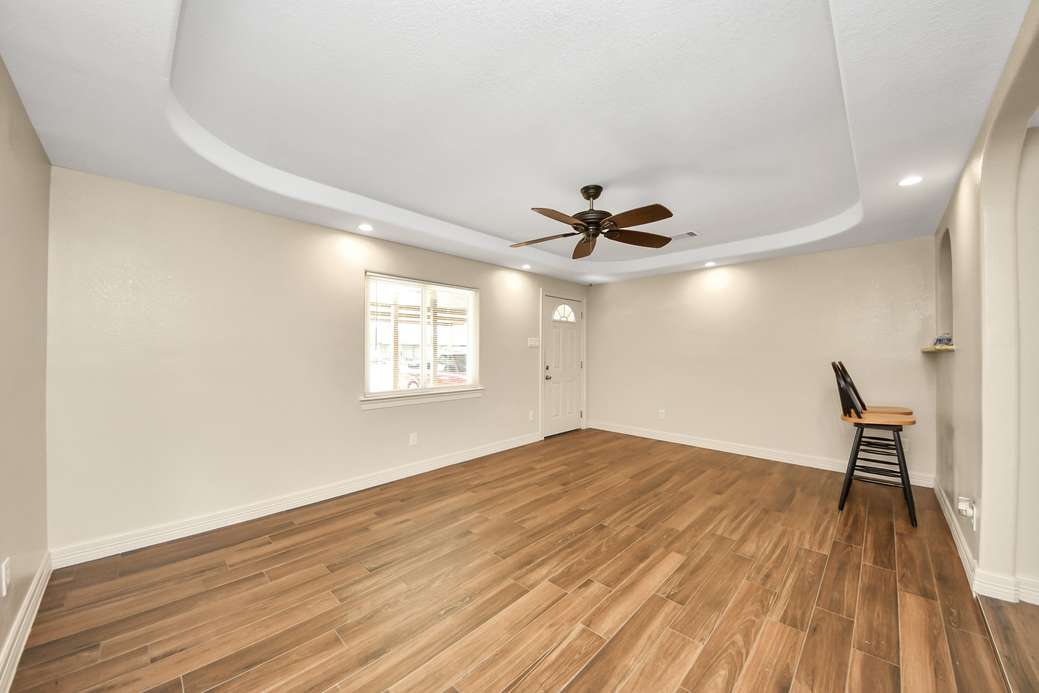 8925 Homewood Lane Houston, TX 77078 - Photo 5 of 28 an empty room with wooden floor fan and windows