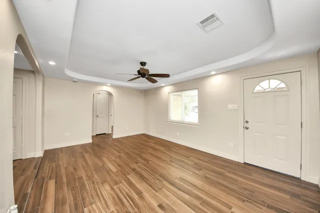 wooden floor in an empty room with a window