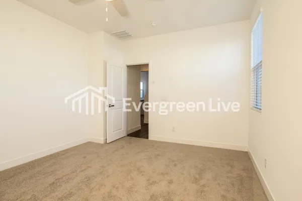 a bathroom with a granite countertop sink mirror vanity and toilet
