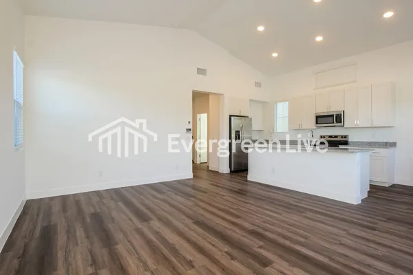 a kitchen with stainless steel appliances granite countertop a sink and a refrigerator