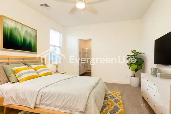 an empty room with a ceiling fan and window