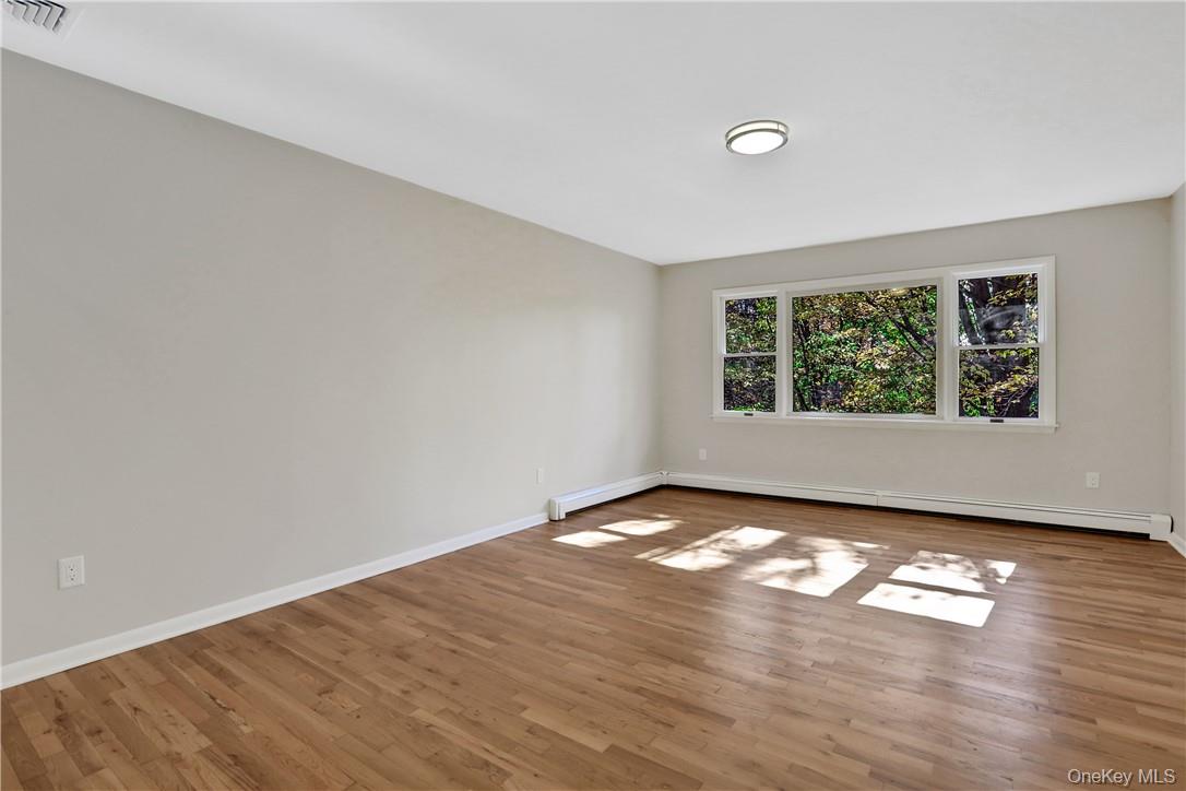2 Requa Street Briarcliff Manor, NY 10510 - Photo 15 of 36 a view of an empty room with wooden floor and a window