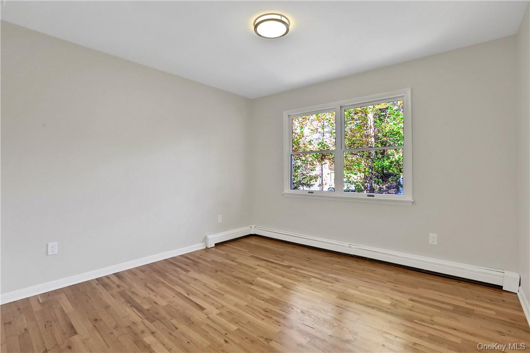 2 Requa Street Briarcliff Manor, NY 10510 - Photo 19 of 36 an empty room with wooden floor and windows