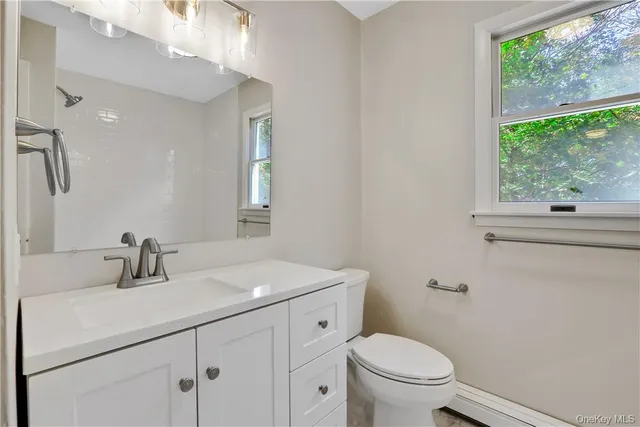 a bathroom with a toilet sink and window