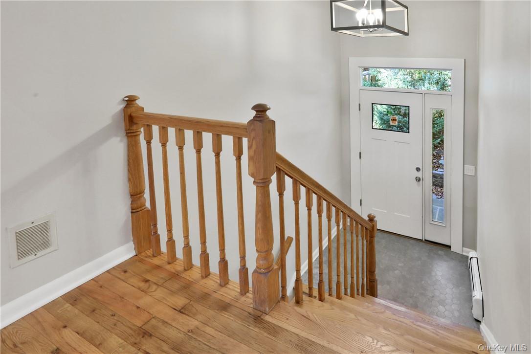2 Requa Street Briarcliff Manor, NY 10510 - Photo 2 of 36 a view of a hallway with wooden floor and stairs