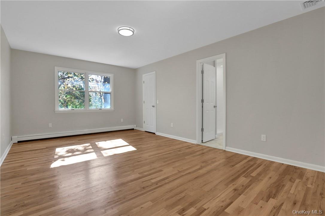 2 Requa Street Briarcliff Manor, NY 10510 - Photo 25 of 36 a view of empty room with window and wooden floor