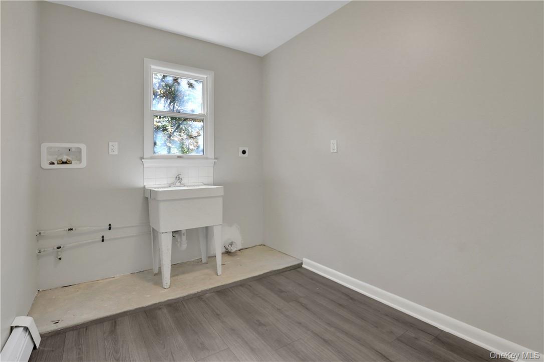 2 Requa Street Briarcliff Manor, NY 10510 - Photo 33 of 36 an empty room with a window and wooden floor
