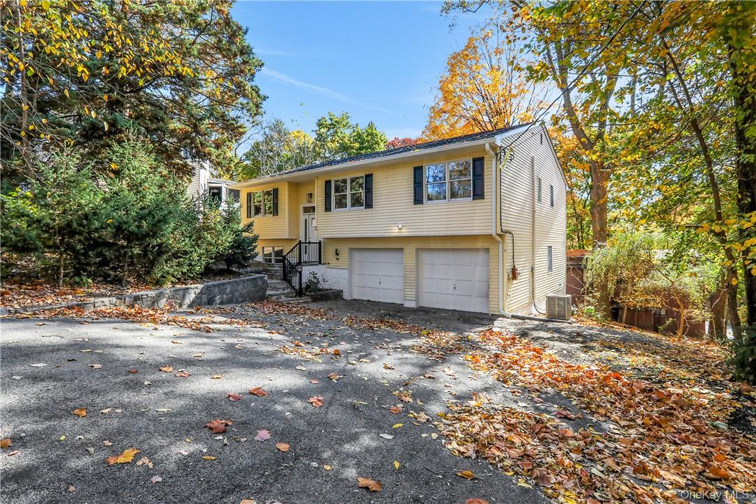 2 Requa Street Briarcliff Manor, NY 10510 - Photo 34 of 36 a front view of a house with a yard and garage