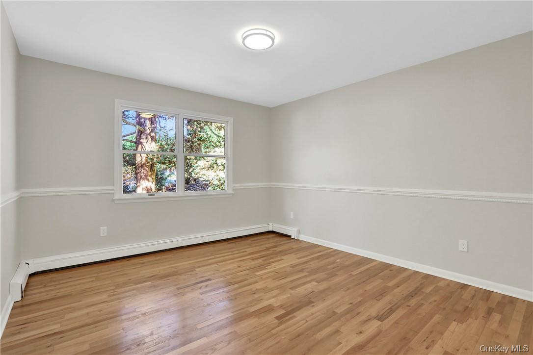 2 Requa Street Briarcliff Manor, NY 10510 - Photo 5 of 36 an empty room with wooden floor and windows