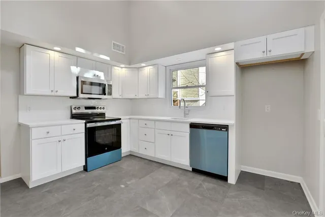 a kitchen with kitchen island a sink stove and refrigerator