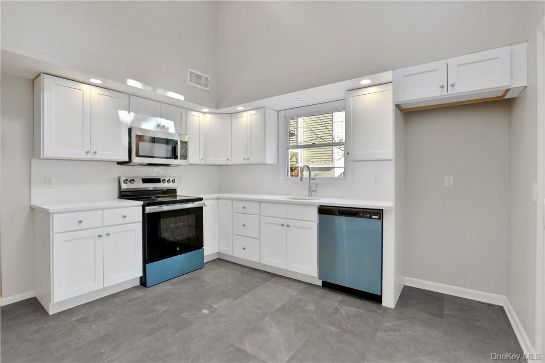 2 Requa Street Briarcliff Manor, NY 10510 - Photo 8 of 36 a kitchen with kitchen island a sink stove and refrigerator